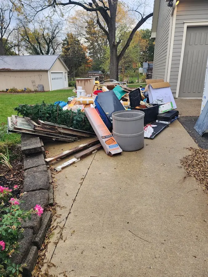 Dumpster being loaded with debris for Estate Cleanout Dumpster Rental in Coon Rapids